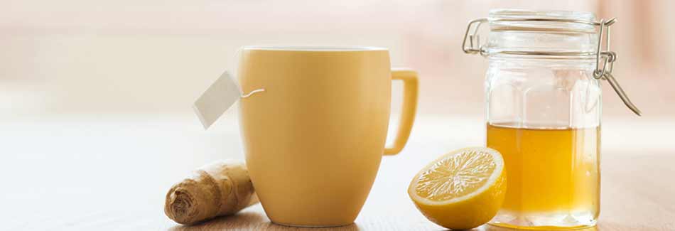 Eine Tasse mit Ingwer, einer Zitrone und Honig